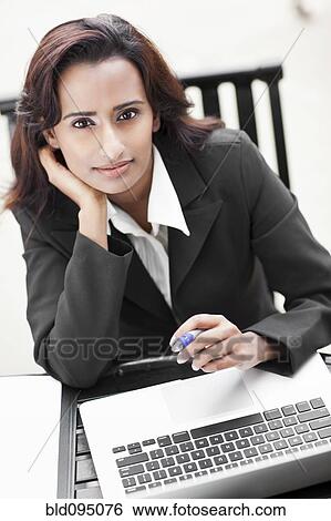 Stock Photograph - Indian businesswoman using laptop. Fotosearch