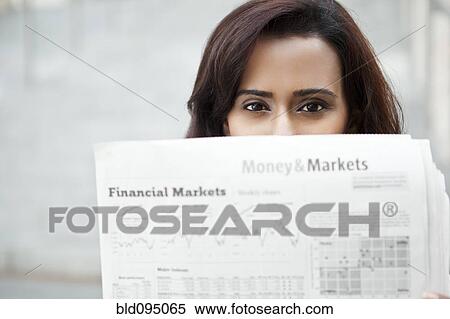 Stock Photography - Indian woman reading newspaper. Fotosearch