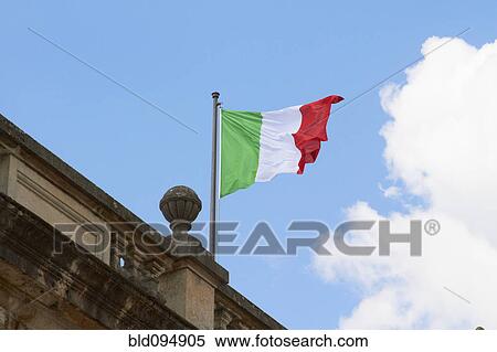 Italian flag fluttering on rooftop View Large Photo Image Stock Photography - Italian flag fluttering on rooftop. Fotosearch