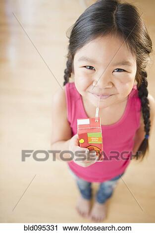Korean girl drinking juice box View Large Photo Image Stock Image - Korean girl drinking juice box. Fotosearch