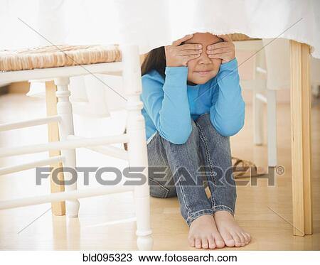 Korean girl hiding underneath table View Large Photo Image Stock Image - Korean girl hiding underneath table. Fotosearch