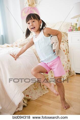 Korean girl leaning against bed in bedroom View Large Photo Image Stock Photo - Korean girl leaning against bed in bedroom. Fotosearch