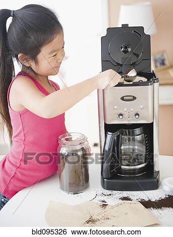 Stock Photograph - Korean girl making coffee. Fotosearch