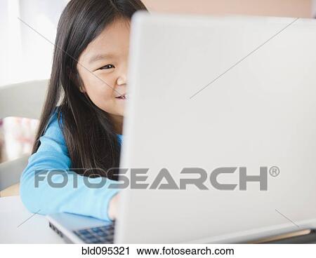 Stock Image - Korean girl using laptop. Fotosearch