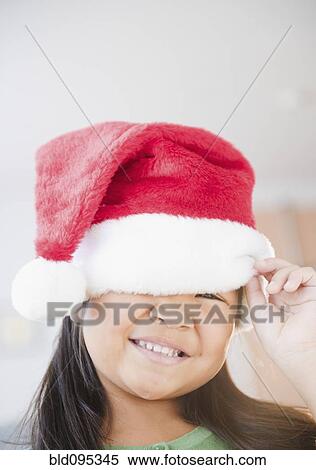 Stock Photography - Korean girl wearing Santa hat. Fotosearch