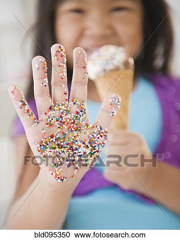 Korean girl with sprinkles on her hand View Large Photo Image Stock Image - Korean girl with sprinkles on her hand. Fotosearch