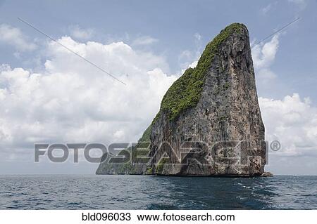 Stock Image - Large rock formation in ocean. Fotosearch