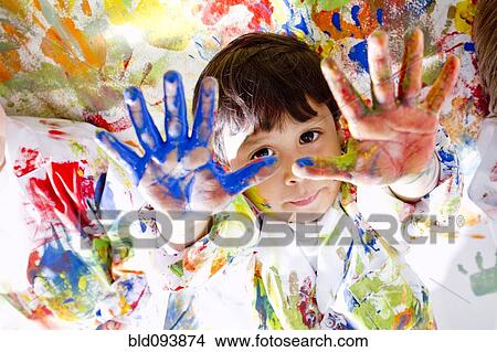 Picture - Messy Hispanic boy finger painting. Fotosearch