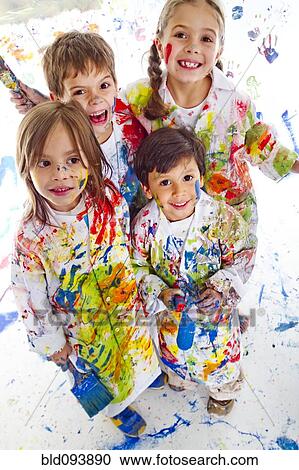 Messy Hispanic children covered in paint View Large Photo Image Stock Image - Messy Hispanic children covered in paint. Fotosearch