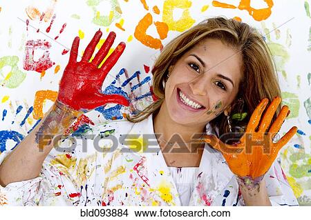 Picture - Messy Hispanic woman finger painting. Fotosearch