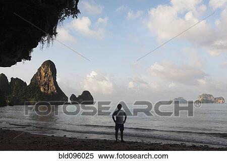 Stock Photography - Person standing on Thai beach. Fotosearch
