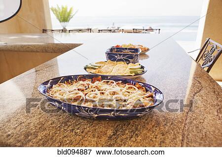 Plates of fresh food on bar View Large Photo Image Stock Photo - Plates of fresh food on bar. Fotosearch