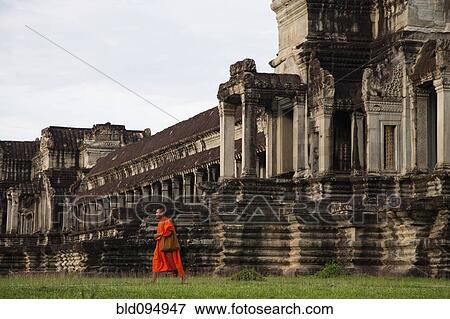 Stock Photo - Priest walking near Angkor Wat temple. Fotosearch