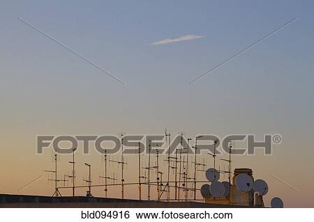 Stock Photograph - Silhouette of television antennas on rooftop. Fotosearch