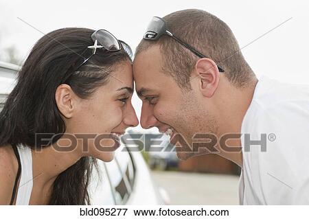 Smiling Hispanic couple looking at each other View Large Photo Image Stock Photo - Smiling Hispanic couple looking at each other. Fotosearch