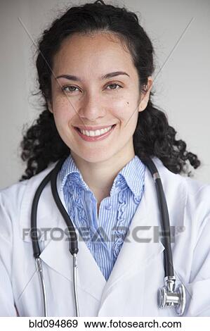 Stock Photo - Smiling Hispanic doctor in lab coat. Fotosearch