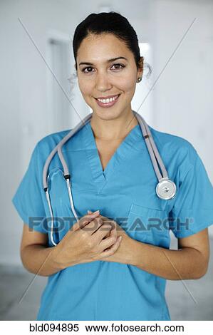 Smiling Hispanic nurse in scrubs View Large Photo Image Stock Photography - Smiling Hispanic nurse in scrubs. Fotosearch