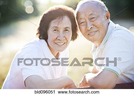 Smiling senior Chinese couple outdoors View Large Photo Image Stock Image - Smiling senior Chinese couple outdoors. Fotosearch