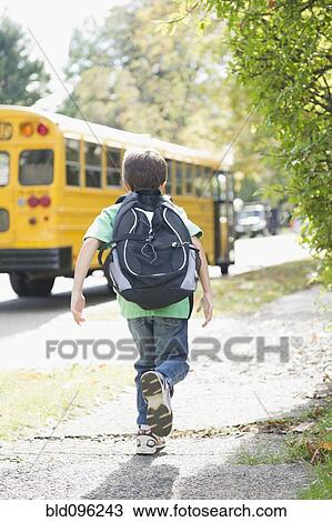Caucasian boy running after school bus View Large Photo Image Stock Image - Caucasian boy running after school bus. Fotosearch