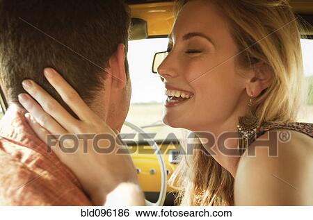 Caucasian couple kissing in car View Large Photo Image Stock Photograph - Caucasian couple kissing in car. Fotosearch