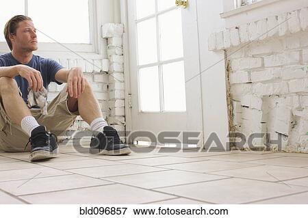 Caucasian man sitting on floor View Large Photo Image Stock Photo - Caucasian man sitting on floor. Fotosearch