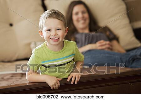 Caucasian mother and son relaxing on bed View Large Photo Image Stock Image - Caucasian mother and son relaxing on bed. Fotosearch