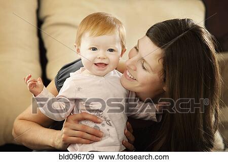 Caucasian mother smiling at baby daughter View Large Photo Image Stock Photo - Caucasian mother smiling at baby daughter. Fotosearch