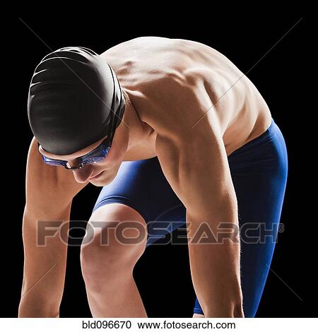 Stock Image - Caucasian teenage boy in swim cap and goggles. Fotosearch
