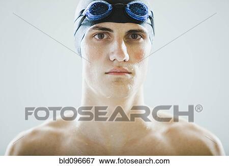Stock Photo - Caucasian teenage boy in swim cap and goggles. Fotosearch