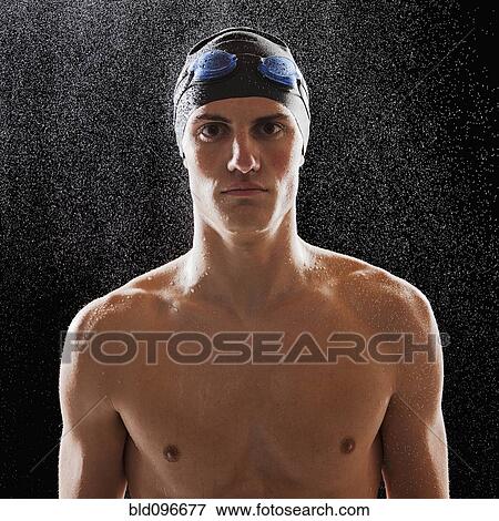 Stock Photo - Caucasian teenage boy in swim cap and goggles. Fotosearch