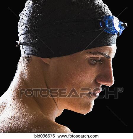 Stock Photograph - Caucasian teenage boy in swim cap and goggles. Fotosearch