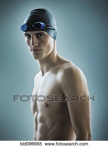 Stock Photography - Caucasian teenage boy in swim cap and goggles. Fotosearch