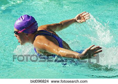 Picture - Caucasian teenager swimming in swimming pool. Fotosearch