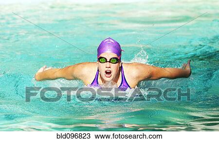 Stock Image - Caucasian teenager swimming in swimming pool. Fotosearch