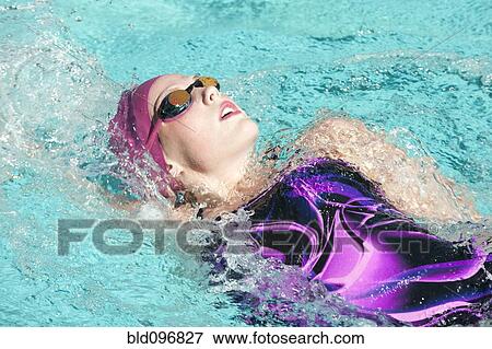 Stock Photo - Caucasian teenager swimming in swimming pool. Fotosearch