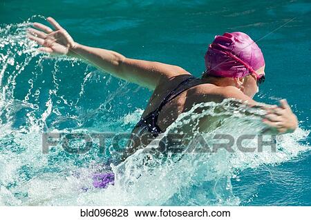 Stock Photo - Caucasian teenager swimming in swimming pool. Fotosearch
