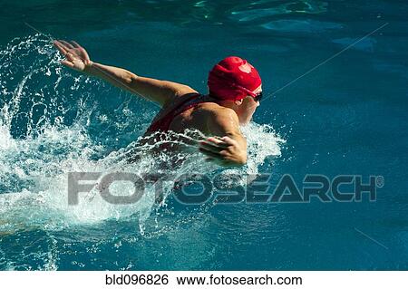 Stock Photograph - Caucasian teenager swimming in swimming pool. Fotosearch