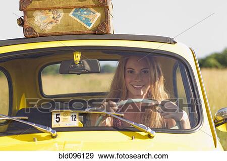Stock Photo - Caucasian woman driving car on road trip. Fotosearch