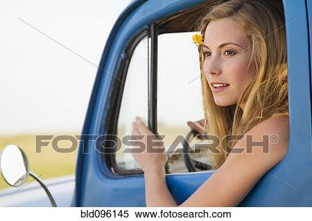Stock Photography - Caucasian woman driving old-fashioned truck. Fotosearch