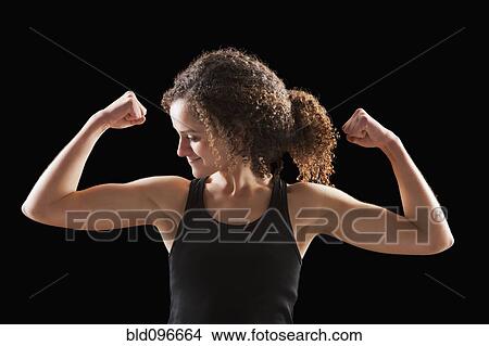 Picture - Caucasian woman flexing biceps. Fotosearch
