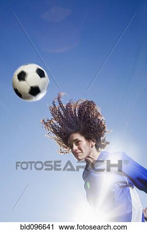 Caucasian woman heading soccer ball View Large Photo Image Stock Image - Caucasian woman heading soccer ball. Fotosearch