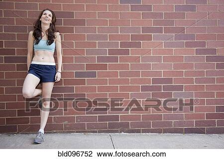 Caucasian woman leaning on wall after exercise View Large Photo Image Stock Image - Caucasian woman leaning on wall after exercise. Fotosearch