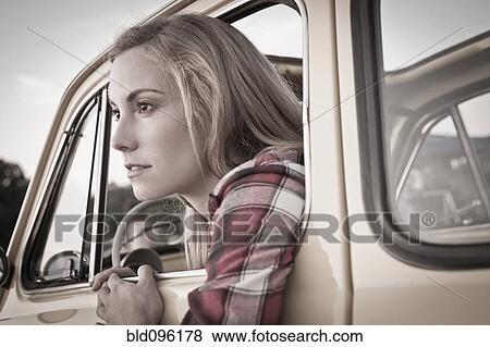 Caucasian woman leaning out of car window View Large Photo Image Stock Photo - Caucasian woman leaning out of car window. Fotosearch