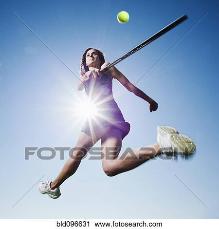 Stock Image - Caucasian woman playing tennis. Fotosearch