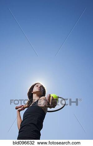 Stock Image - Caucasian woman playing tennis. Fotosearch