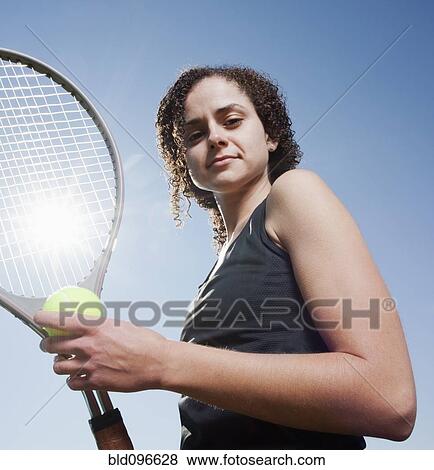Stock Photo - Caucasian woman playing tennis. Fotosearch