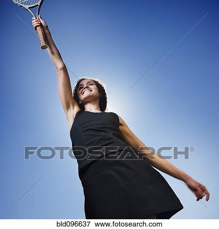 Stock Photo - Caucasian woman playing tennis. Fotosearch