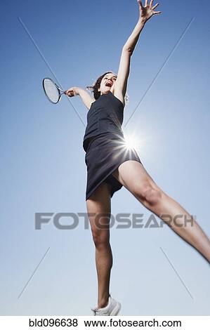 Stock Photo - Caucasian woman playing tennis. Fotosearch