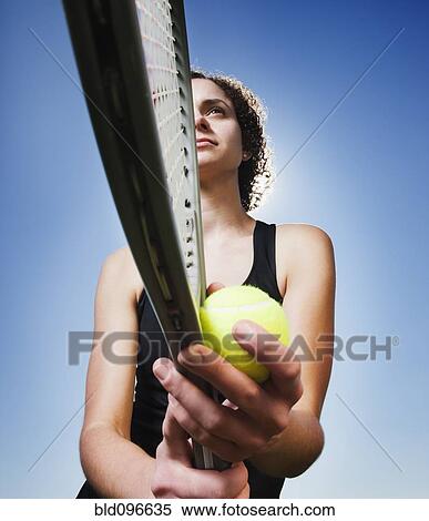Stock Photography - Caucasian woman playing tennis. Fotosearch