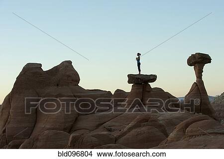 Caucasian woman practicing yoga on top of rock formation View Large Photo Image Picture - Caucasian woman practicing yoga on top of rock formation. Fotosearch